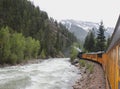 Steam Engine Train Travels Along a River in the Mountains Royalty Free Stock Photo