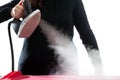 Steam iron in hand of hostess on a white background Royalty Free Stock Photo