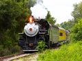 Steam locomotive barreling down the tracks Royalty Free Stock Photo