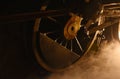 steam locomotive iron wheel with smoke floating on railway in night