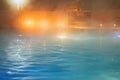 Steam over warm pool in the winter outdoors. Spa salon. Out of focus due to dense white fumes.