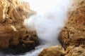 Steam over water running over rocks in cliffs