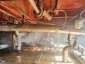 Steam from the pipe. under pressure in production. factory breakdown. gas leak. Leakage of steam in heat pipeline interior