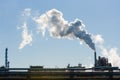 Steam pouring from the chimney of a petroleum refining plant