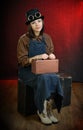 Steam punk girl porter sitting on suitcase Royalty Free Stock Photo