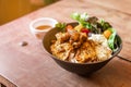 Steam rice with Chicken Satay and fried egg served with salad including green oak and tomato. Served with Satay sauce