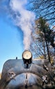 Steam rises from an old black steam locomotive