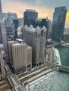 Steam rises from skyscrapers during frigid evening along a frozen Chicago River Royalty Free Stock Photo