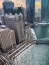 Steam rises from skyscrapers during frigid evening along a frozen Chicago River Royalty Free Stock Photo