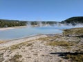 Steam rising from blue hot spring in Yellowstone National Park Royalty Free Stock Photo