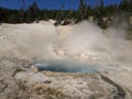 Steam rising from blue hot spring at Yellowstone National Park