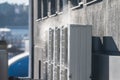 Steam rising from heat pumps on the side of abuilding.. Royalty Free Stock Photo