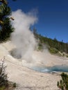 Steam rising high from blue hot spring at Yellowstone National Park Royalty Free Stock Photo