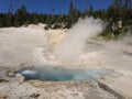 Steam rising high from blue hot spring at Yellowstone National Park Royalty Free Stock Photo