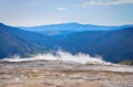 Steam rising from a hot spring in a Yellowstone landscape Royalty Free Stock Photo