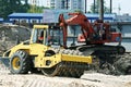 Steam roller and excavator on construction site Royalty Free Stock Photo