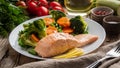 Steam salmon and vegetables, Paleo, keto, fodmap diet. White plate on old rustic wooden table, side view, long banner