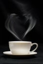 Steam in the shape of a heart over a cup of tea. Royalty Free Stock Photo