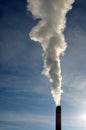 Steam from stack against blue sky