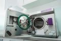 Steam sterilizer autoclave with the door open in a medical laboratory