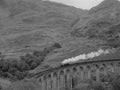 A steam train on an arch bridge, black and white