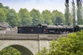 a steam train crossing a bridge in Saint leonard de Noblat, France