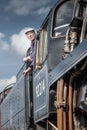 Steam train driver looks out of his cabin