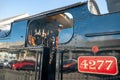 Steam train engineer checking the gauges.