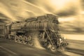 Steam train goes fast on the night station background. Royalty Free Stock Photo