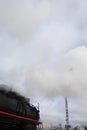 Steam train locomotive on the station with old railway semaphore in clouds of steam Royalty Free Stock Photo