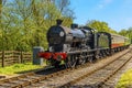 A steam train on a railway line in Sussex, UK Royalty Free Stock Photo