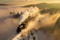 a steam train traveling through a snowy landscape Royalty Free Stock Photo