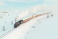 a steam train traveling through a snowy landscape Royalty Free Stock Photo