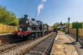 Steam trains at a station on a railway line in Sussex, UK