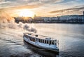 Steamboat on Alster Lake in Hamburg with cityscape in background during sunset Royalty Free Stock Photo