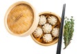 Steamed baozi dumplings stuffed with meat in a bamboo steamer. Isolated on white background, top view. Royalty Free Stock Photo