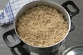 Steamed barley grits in a traditional aluminum food steamer close up