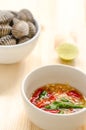 Steamed blanched clams in white bowl and spicy dipping sauce Royalty Free Stock Photo