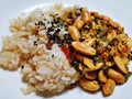 Steamed Brown Rice and Various Peanuts and Sesame on White Plate