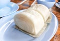Steamed bun on a plate on a wooden table Royalty Free Stock Photo