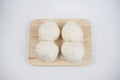 Steamed buns with minced pork on bamboo cutting board. Chinese food dim sum style on white background. Royalty Free Stock Photo