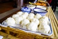 Steamed buns on tray on bamboo table ready to eat in the morning, asian food, side view Royalty Free Stock Photo