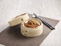 Steamed Chicken Claw with Black Bean Sauce served in a wooden bowl with chopsticks isolated on mat side view on grey marble Royalty Free Stock Photo