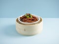 Steamed Chicken Claw with Black Bean Sauce served in a wooden bowl with chopsticks isolated on mat side view on grey marble Royalty Free Stock Photo