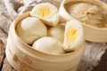 Steamed Chinese bun with custard cream stuff filling in bamboo wooden container. horizontal Royalty Free Stock Photo