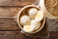 Steamed Chinese bun with custard cream stuff filling in bamboo wooden container. horizontal top view Royalty Free Stock Photo