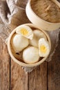 Steamed Chinese bun with custard cream stuff filling in bamboo wooden container. Vertical top view Royalty Free Stock Photo