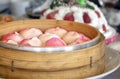 Steamed Chinese Longevity Peach Birthday Buns Served in a Bamboo Steamer