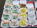 Steamed chives dumplings,Thai Coconut muchkins, tapioca pork and mung bean rice-crepe in foam package box for sell in the market