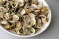 Steamed clams in garlic sauce in a white bowl. Royalty Free Stock Photo